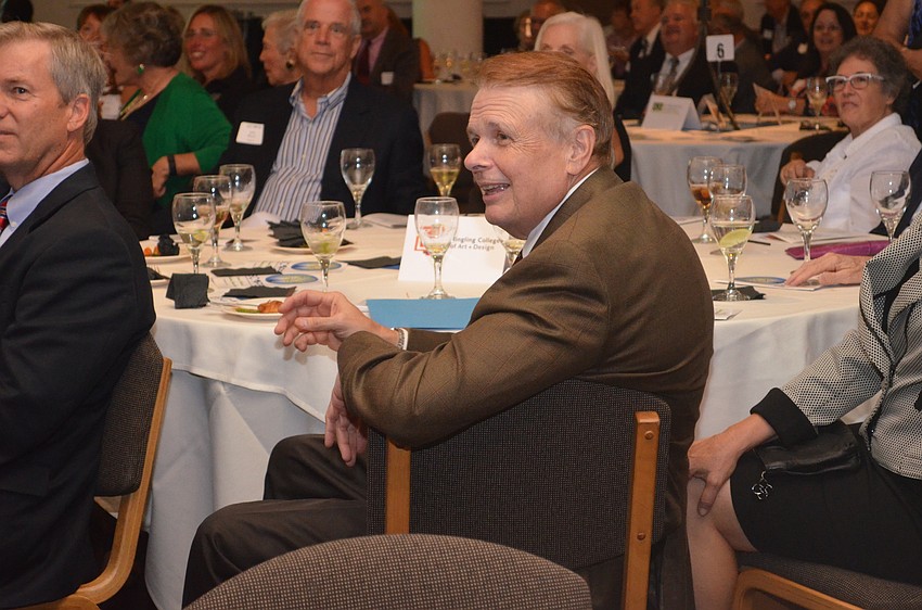 Ringling College of Art and Design President Larry Thompson sings along.