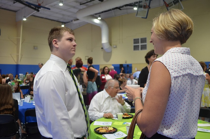 CYD Youth Ambassador Jakob Lawrence interacts with Kelly Romanoff.