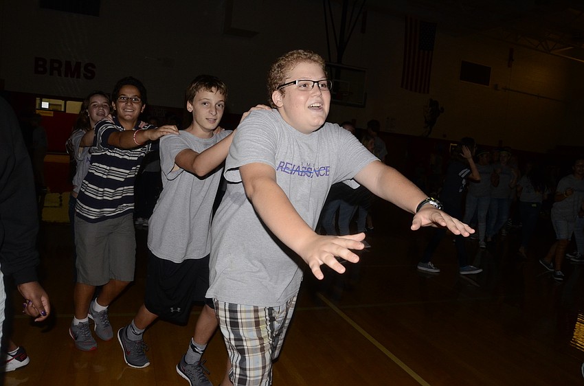 Tommy Suba guides a train around the gym.