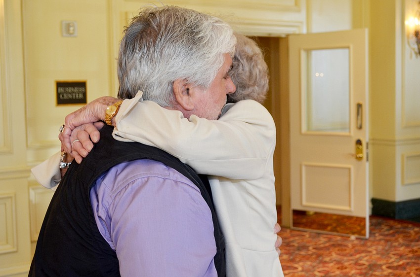 Renaissance Woman of the Year 2015 Betty Schoenbaum giving one of her famous “heart to heart” hugs to Cliff Roles.