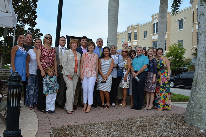 Representatives of funds receiving a plaque gather for a photo.