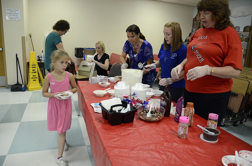 Samantha Pisani eyes the toppings to make a decision.