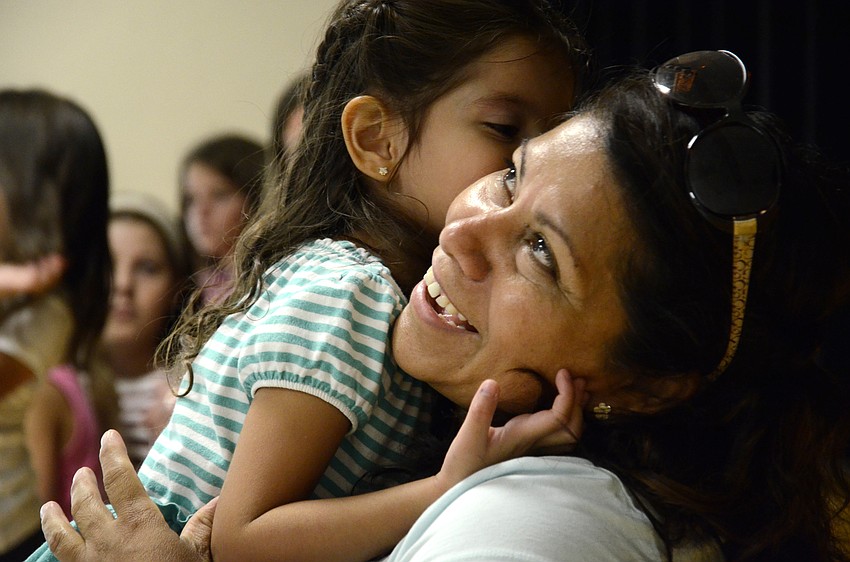 Isabella Hadfeg tells something funny to her mother, Maria, during the Ice Cream Social.