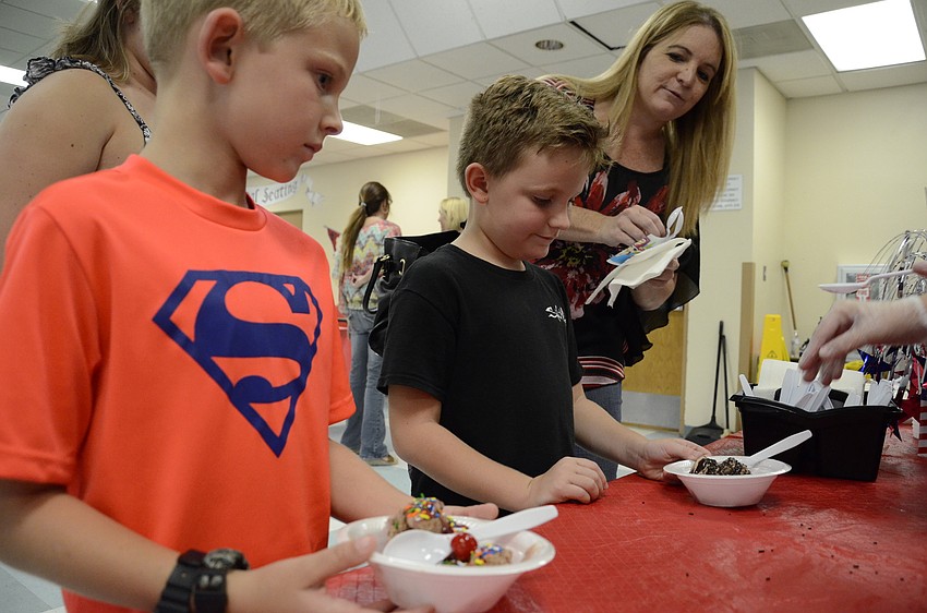 Jaxson Pate and his best friend, Timmy Swanson, pick out their toppings with a little help from Theresa Pate.