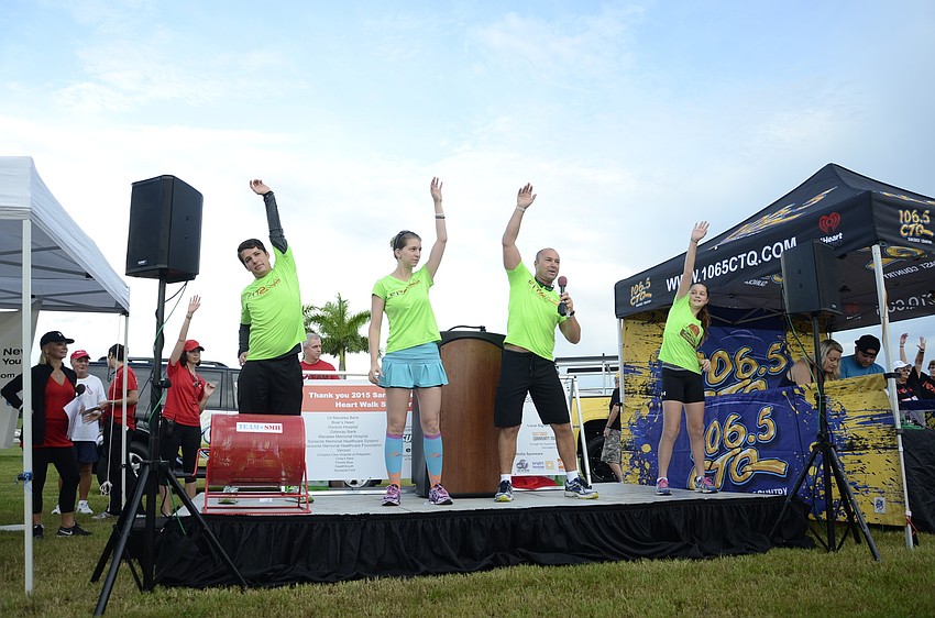 Jordan Washer, Montana Ross, Andy Olday and Emilia Olday with Fit 2 Run lead a warm-up session before the walk.