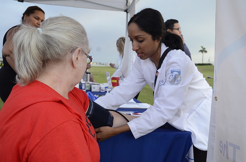 Brenda Gillette gets her blood pressure tested by thrd-year LECOM student Preethi Yarabothu.