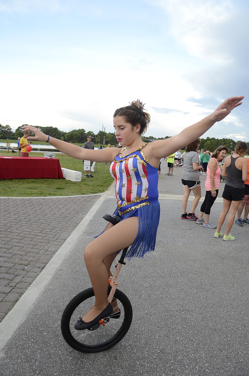 Aunna Twig with Sailor Circus wheels around in her unicycle.