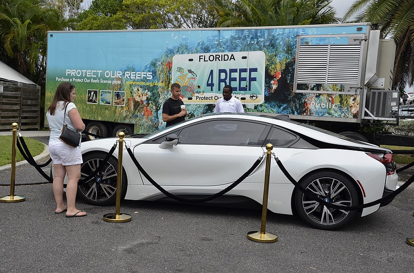 Jennifer and Joel Baker examine a hybrid BMW.