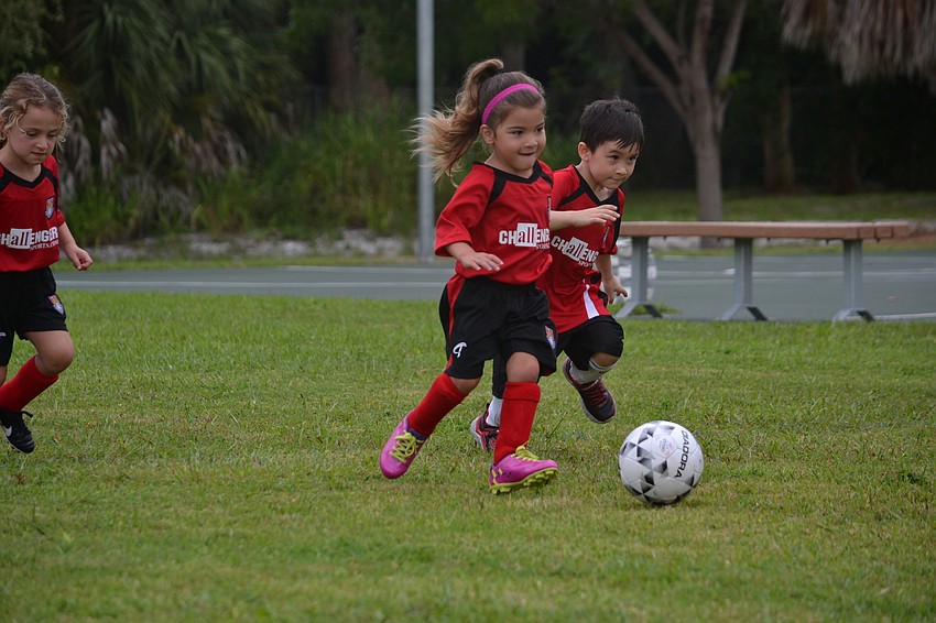 The Sailfish team keeps up with the soccer ball.