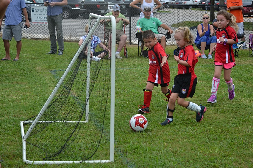 Teammates Trevor Lujan and Molly Cocozza score a goal together.