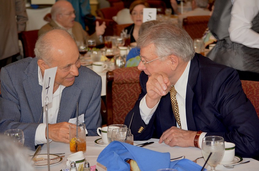 Jan Nogradi and John Hockenberry shares stories while waiting for lunch.