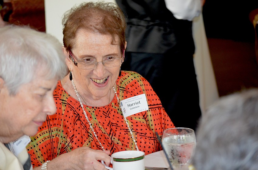 Harriet Goldstein sips on tea and chats with her friends.