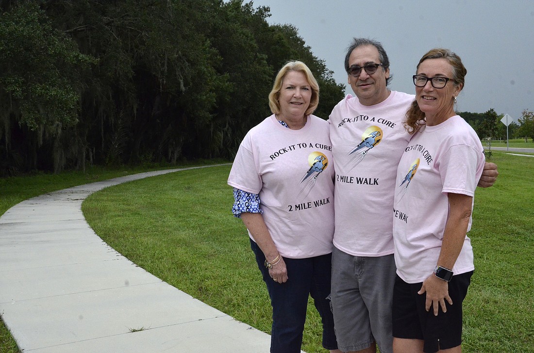 Margo Diener, left, organized the walk with help from Peter and Sandy Gatti, right. Peter Gatti sponsored the walk with his business, rockitradioman.com.