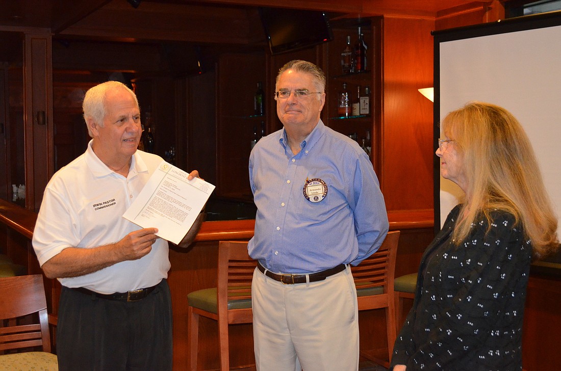 Commissioners Irwin Pastor and Lynn Larson present Kiwanis Club of Longboat Key President Armando Linde, center, with a thank you letter Thursday for the club's donation to Bayfront Park.