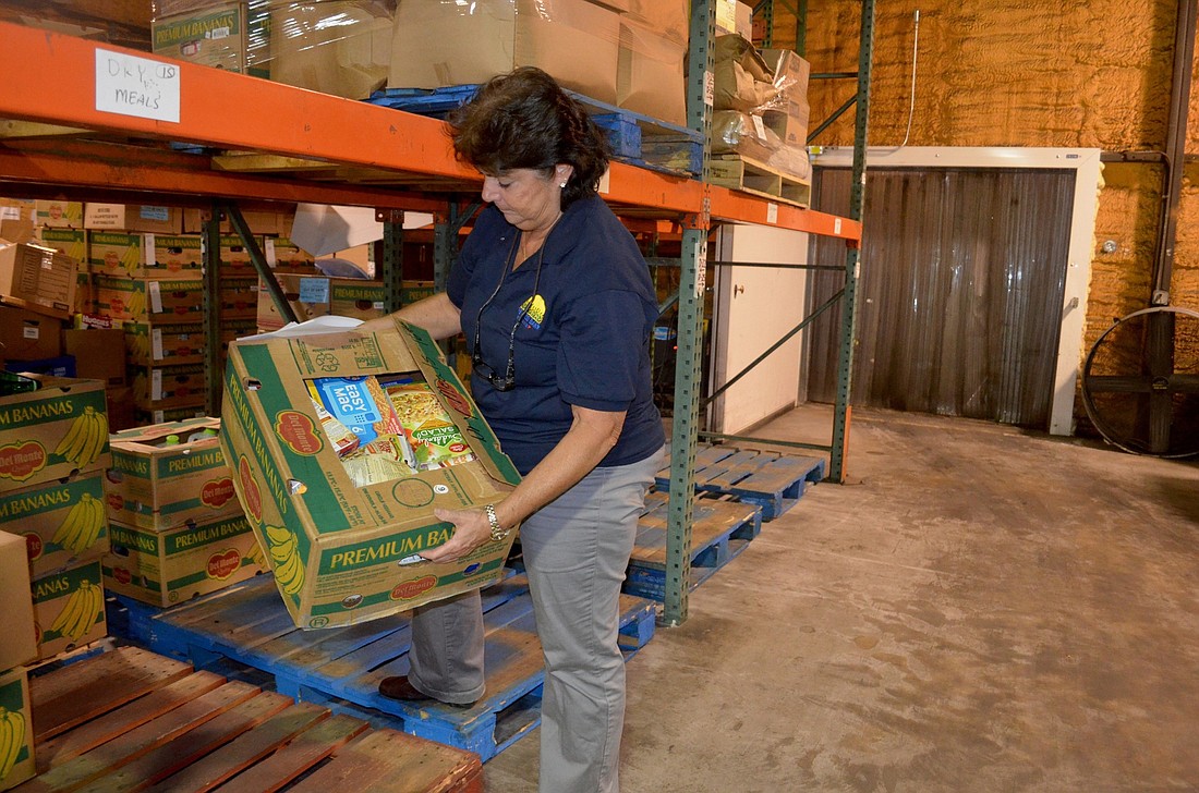 Food Bank of Manatee Director Cindy Sloan unloads one of the few  boxes of meals she has left in the warehouse.