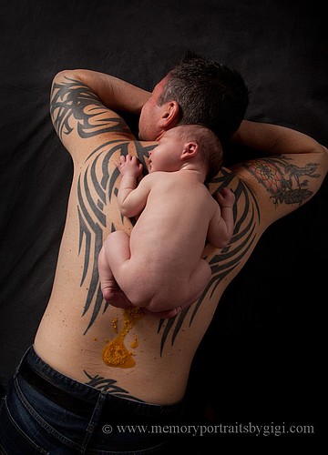 Asher Renick, pictured at 10-days old, rests between the wing tattoos on his father, Mark's, back. This image has gained worldwide attention.