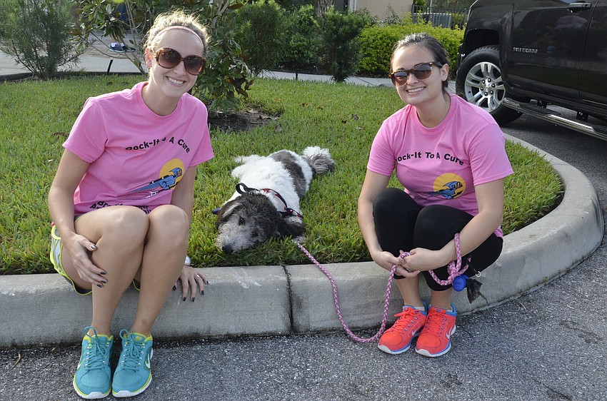 Rachel Liggins and Libby Bolles with her dog, a pyrepoo, or a Pyrenees poodle mix, named Potus.