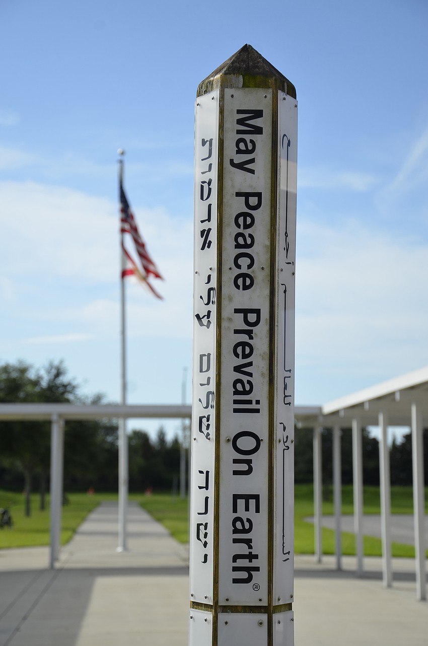 The peace pole stands in the courtyard of Gullett Elementary, and reads 