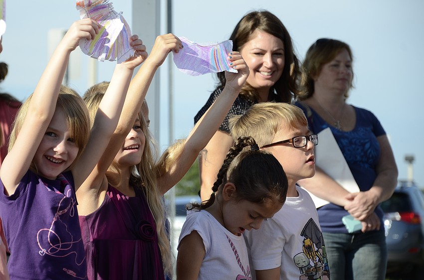 Kindergarteners Alaina Duke and Emilie Dixon hold up their Picasso-inspired doves of peace.