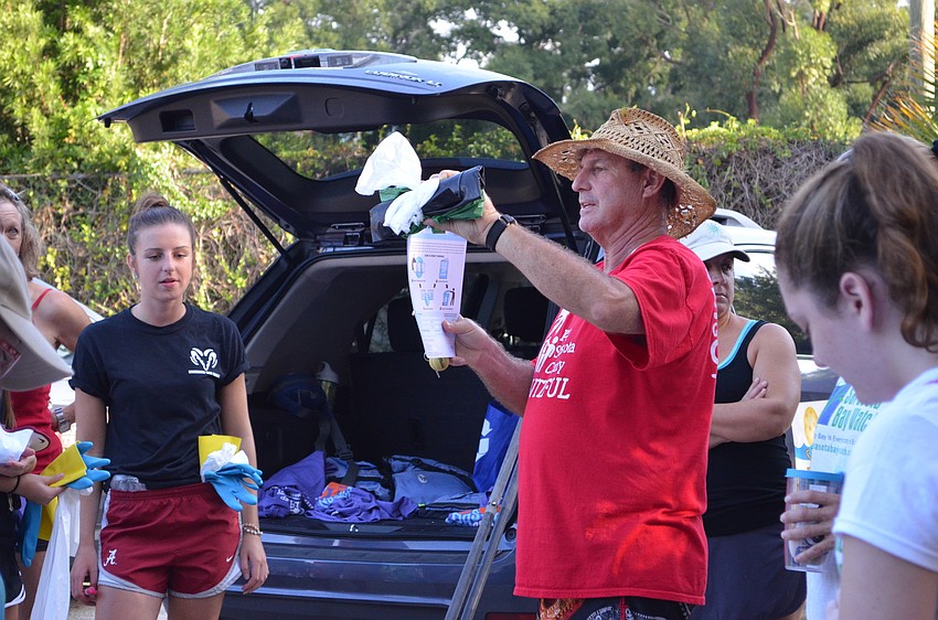 Russell Elefterion gives directions to volunteers for collecting trash.