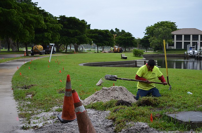 A construction crew works to replace a portion of an underground power line Sept. 17 along Harbourside Drive.