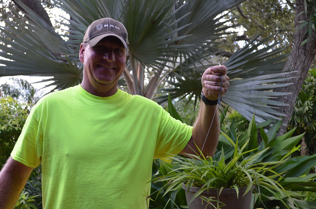 John Gilliam helps pick up plants donated by the Sarasota Garden Club for Habitat for Humanity Monday morning.