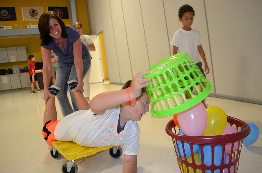 Judy and Hayden Young gather as many balloons as they can during the Hungry Hippo challenge.