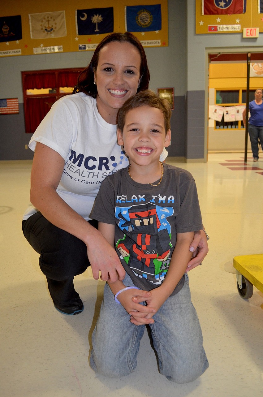 Valerie Cruz and Jovan Rivera wait for their turn to play a game.