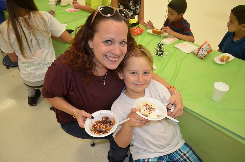 Amy Hendel and her son, Jake, snack on cold treats.