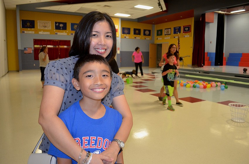 Virginia Villavroza and her son, Joaquin, take a break from rounds of Hungry Hippo.