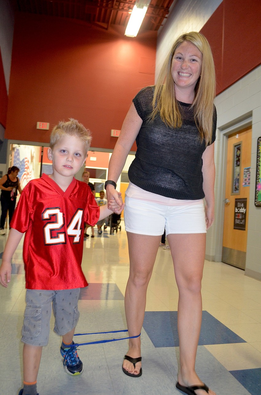 Grady Johnson and his mother, Shaara, maneuver down the hallway during the three-legged race.