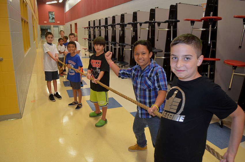 Elementary-aged boys competed against their mothers in a round of Tug of War.