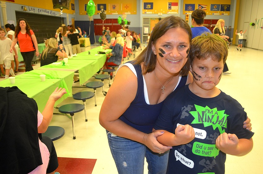 Amanda Hirst says cheese beside her son, Clayton.
