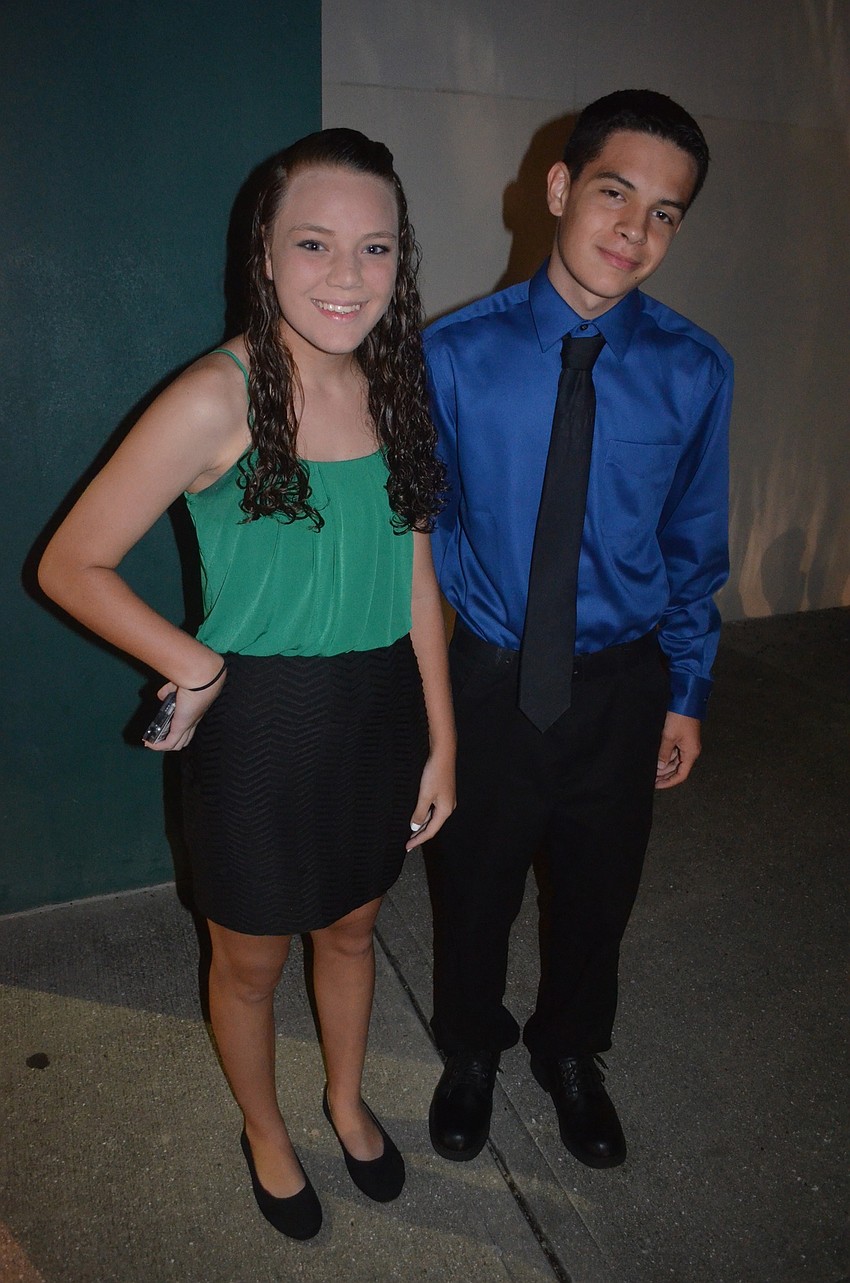 Friends Alexandria Seneck and Christian Marrero say cheese while waiting to enter the dance.