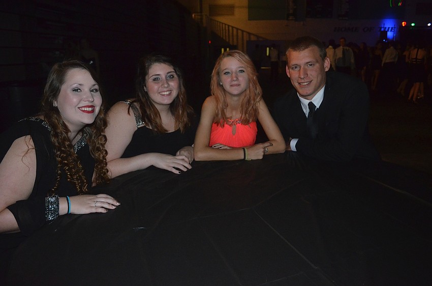 Cora Brewer, Harley Anderson, Kristalynn Smith and Nathan Smith enjoy quiet(er) time with friends at a table.