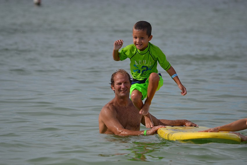 Gabriel Bishop playfully bails from his surfboard.