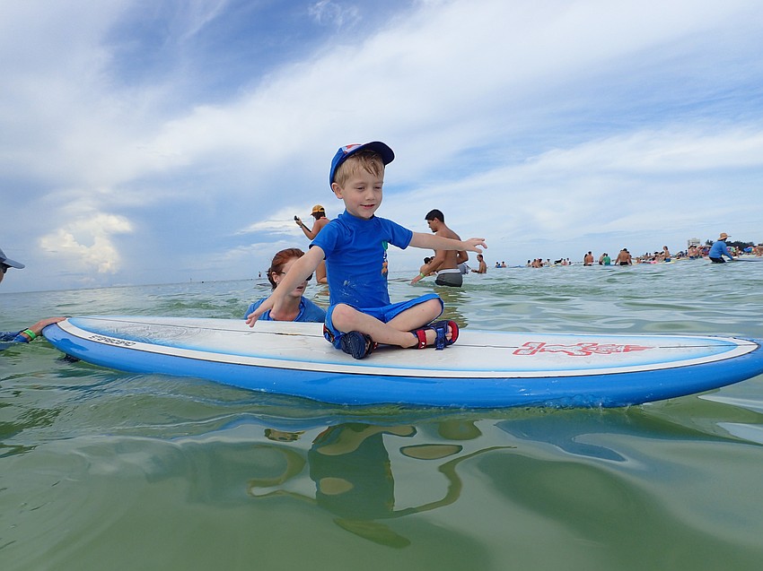 Benjamin Armstrong feels the breeze aboard a surfboard.