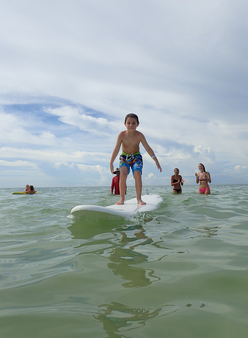 Colin Manning learns to surf at the Hang Ten for Autism event.