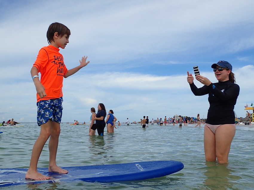 Hayden Joyner waves to his mother Jennifer Joyner.