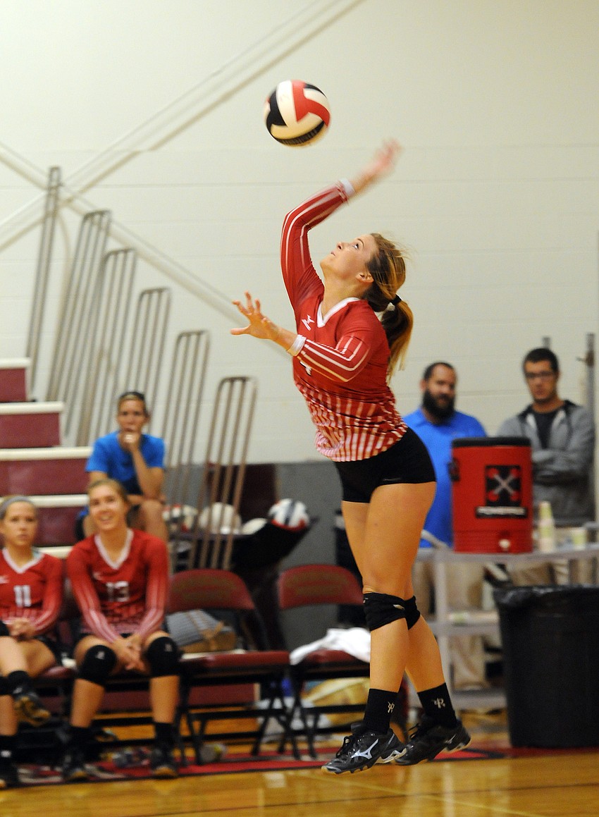 Cardinal Mooney setter Annie Shaw serves the ball in the first set.