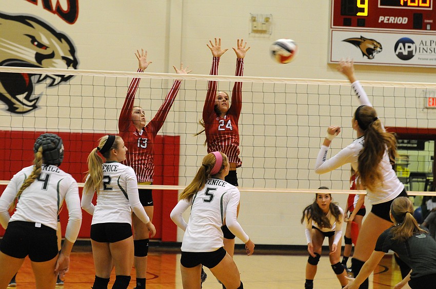 Cardinal Mooney's Brooke Picchi and Keri McMahon go up for a block in the first set.