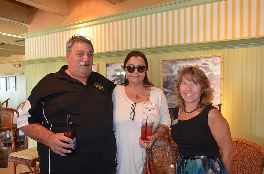 Joe and CJ Bader, of Siesta Trolley, and chamber volunteer Denise Goebel