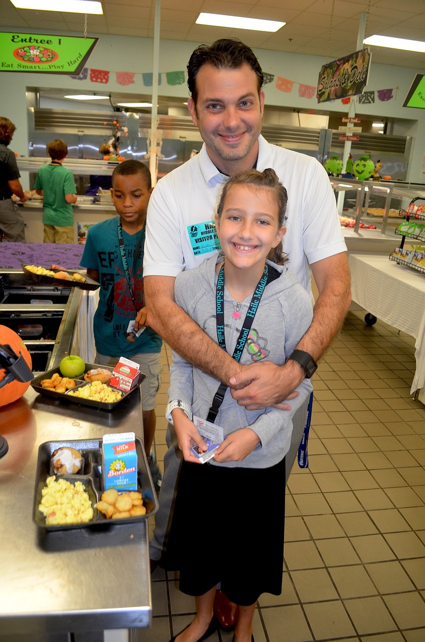 Matt and Kaiya Merrill pick out their favorite breakfast choices.