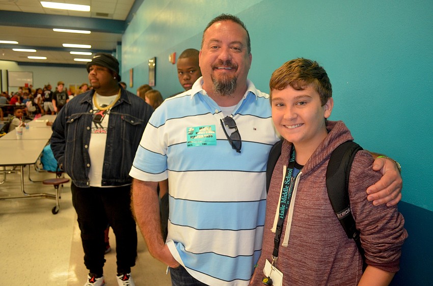 Mike and Justin Ayoub wait their turn in the breakfast line.