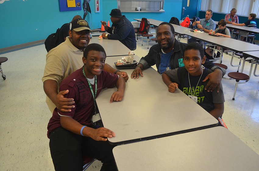 Euell Davis Sr. and his son, Euell Davis Jr., enjoy talking with friends, Brad and Jordan Cooper.