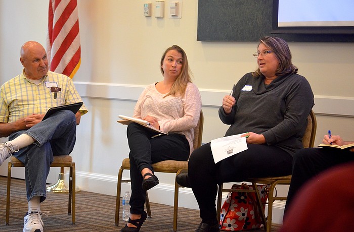 Protect Our Ponds task force member Joe Sidiski and Operations Office Manager Tracy Hunt listen to Michelle Atkinson's explanation of landscape best practices.