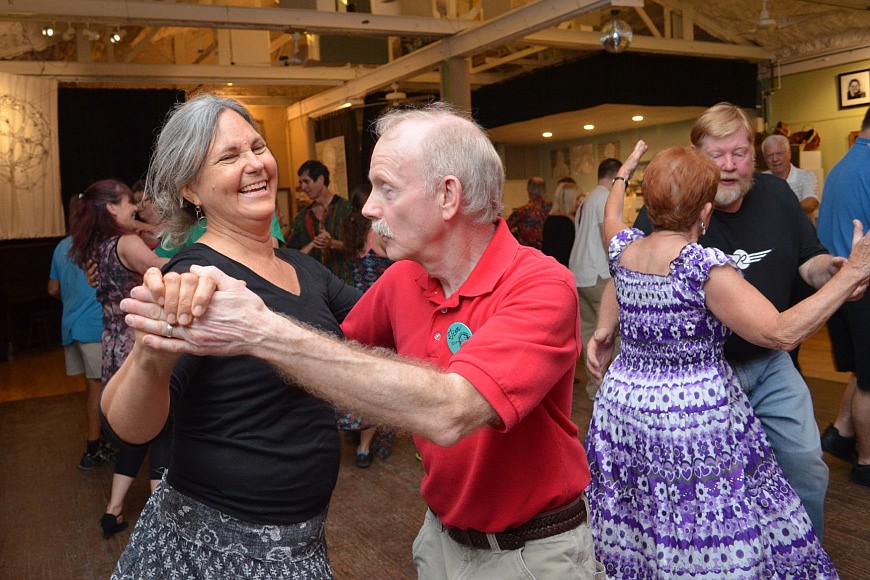 Lisa Bohn follows Tim Tuoheyâ€™s lead on the floor at the monthly Contra dance in March at Fogartyville Community Media & Art Center.