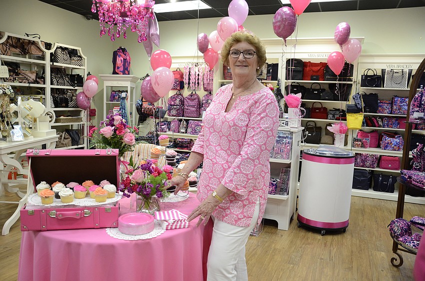 Joan Bradley poses beside the Vera Bradley display.