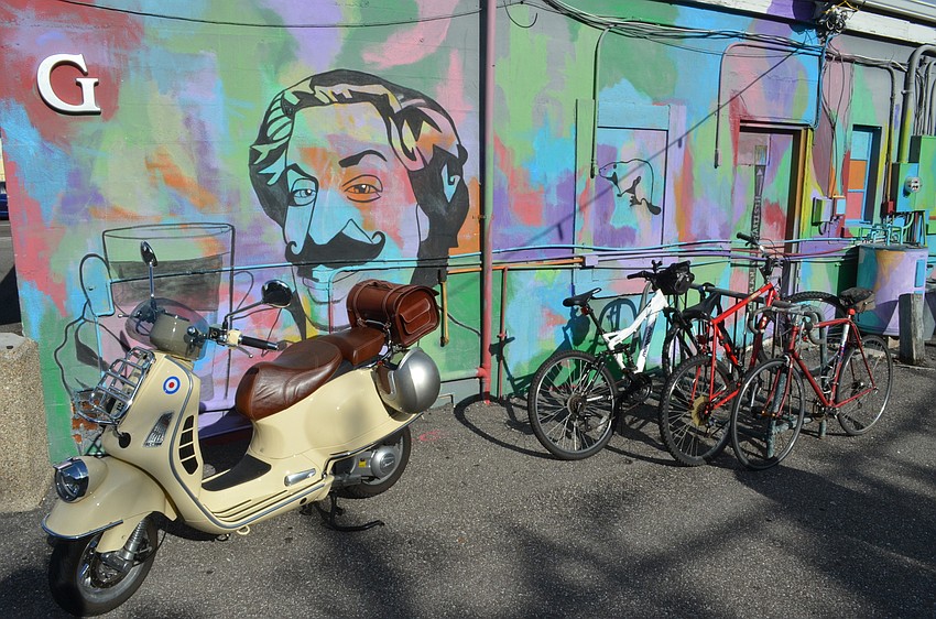 Local artist Truman Adams added a ton of color and the faces of Growler's Pub's dedicated staff to the back of the local favorite bar.