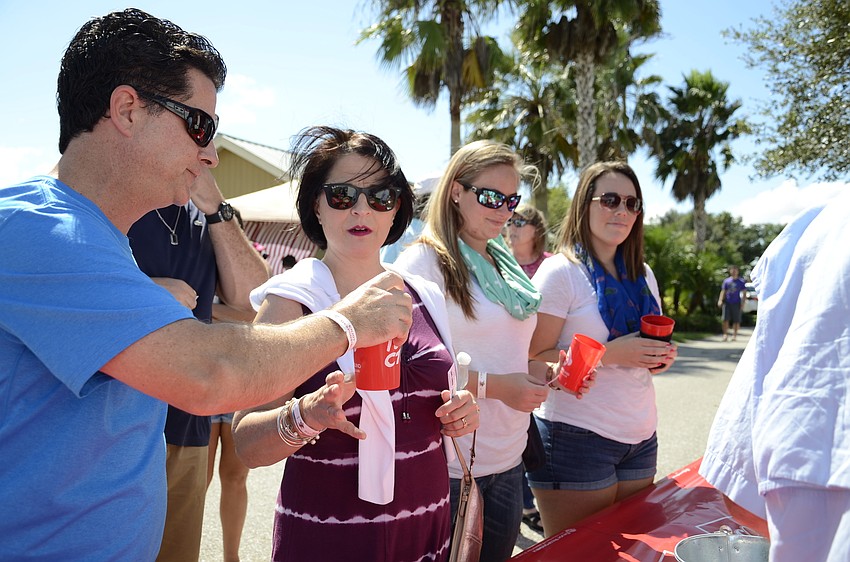 Jeff Charlotte gives his wife, Virginia, a taste of his beer from Blue Point Brewing.